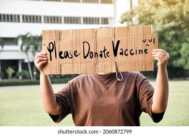 Protester Holds Paper Which Has Texts “Please Donate Vaccine“ , Concept For Calling Rich Countries Donate Covid-19 Vaccines To Poor Countries Around The World.