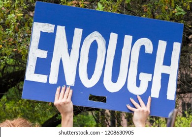 A Protester Holds Sign ENOUGH At The March For Our Lives Rally