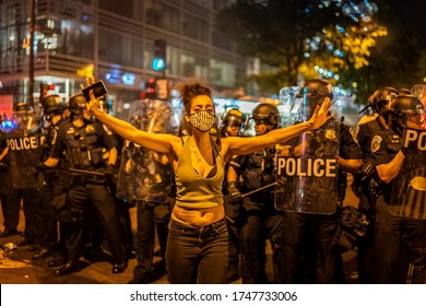 A protester was walking away from policemen peacefully. Many protesters gathered around in front of White House in Washington DC on 5/31/2020. 