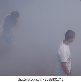 protesters with a child in the smoke