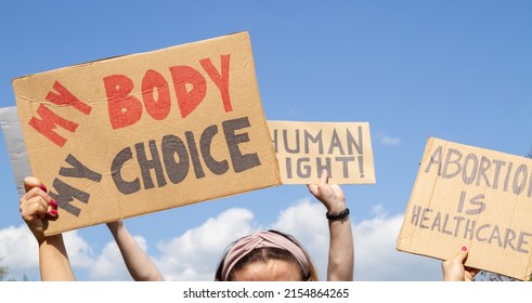 Protesters Holding Signs My Body My Choice, Abortion Is Healthcare, Human Right. People With Placards Supporting Abortion Rights At Protest Rally Demonstration.