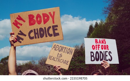 Protesters holding signs My Body My Choice, Bans Off Our Bodies, Abortion Is Healthcare. People with placards supporting abortion rights at protest rally demonstration. - Shutterstock ID 2155198705