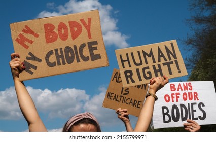 Protesters Holding Signs My Body My Choice, Human Right, Bans Off Our Bodies, Abortion Is Healthcare. People With Placards Supporting Abortion Rights At Protest Rally Demonstration.