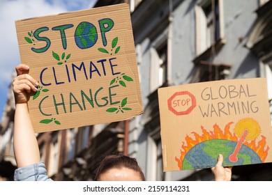 Protesters Holding Signs Stop Climate Change And Stop Global Warming. People With Placards At Protest Rally Demonstration Strike.