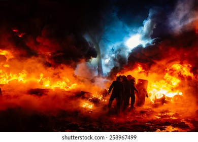 Protesters walk on fire - Shutterstock ID 258967499