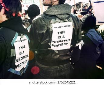 Protesters Wearing Signs Saying 