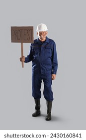 Protesting miner man with placard on grey background