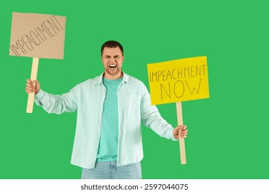 Protesting young man holding placards on green background