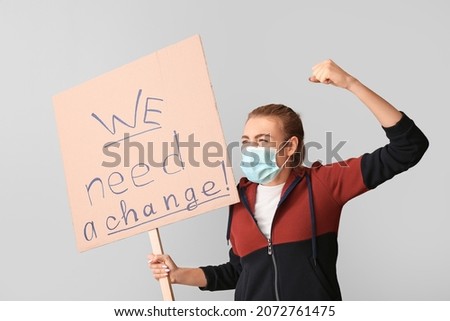 Protesting young woman on light background. Impeachment concept