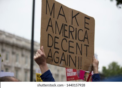 A Protestor Holds A Political Banner With Make America Decent Again Message