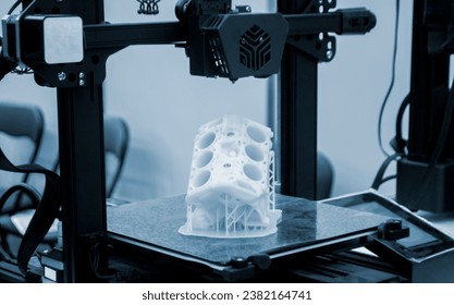 Prototype of car engine printed on 3D printer from molten white plastic on working surface 3D printer. Three-dimensional model. Additive progressive modeling technology. Modern new printing industry. - Powered by Shutterstock