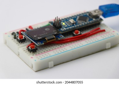 Prototype project built on breadboard with OLED display and programmable microcontroller, STEAM or STEM projects concept