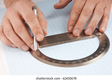 Protractor In Hand On Graph Paper