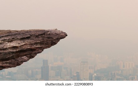 
A protruding section of rock cliff with city views below. - Shutterstock ID 2229080893