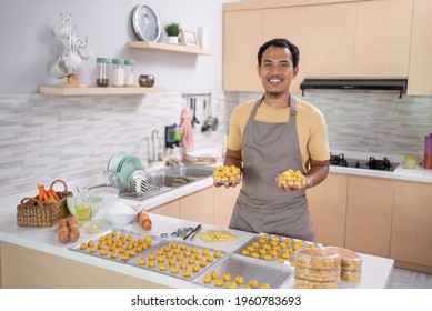 Proud Asian Young Man With His Cooking Smiling To Camera. Making Nastar Cake For Eid Mubarak At Home. Small Business Owner With His Product