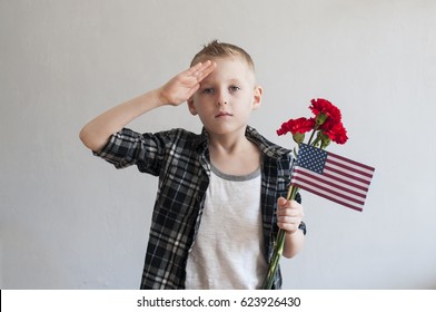 Proud  Boy Celebrating Memorial Day With Flowers And American Flag