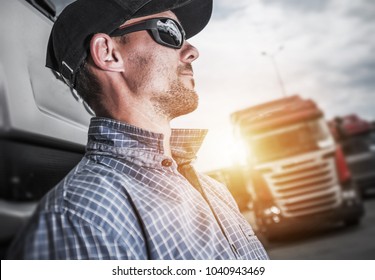 Proud Caucasian Semi Truck Driver Portrait In Front Of His Truck.