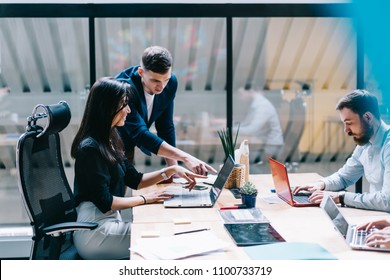 Proud ceo pointing on laptop computer and discussing graphic presentation made by creative female designer during working process in IT company.Office employees using laptops and internet connection - Powered by Shutterstock