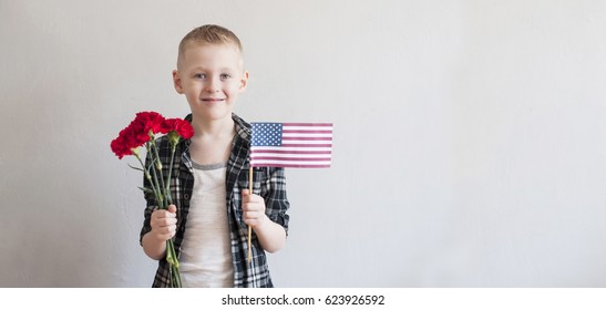 Proud Cheerful Boy Celebrating Memorial Day With Flowers And American Flag