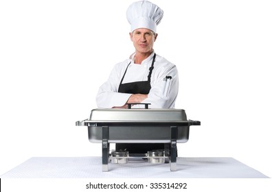 Proud Chef Standing Behind A Food Warmer - Isolated