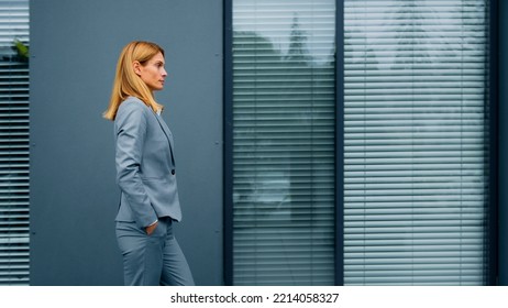 Proud Confident Stylish Woman Leader Boss Professional Worker In Formal Suit Walking Down Street Against Backdrop Of Office Building Successful Caucasian Serious Businesswoman Walk Outdoors Side View