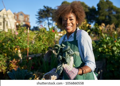 Proud Diverse Millenial Posing With Freshly Picked Kale At Urban Community Communal Garden