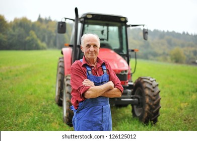 Proud Farmer Standing In Front Of His Red Tractor