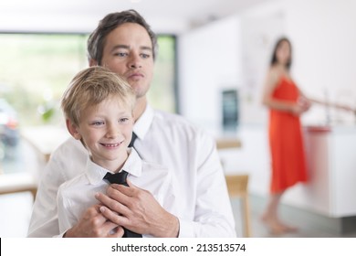 Proud Father Helping His Boy To Put His Tie