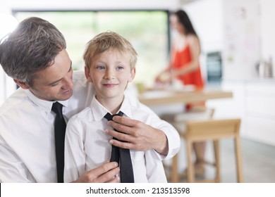 Proud Father Helping His Boy To Put His Tie