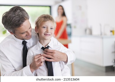 Proud Father Helping His Boy To Put His Tie