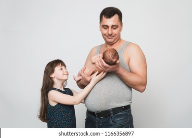 Proud Happy Adult Poor Dad With Daughter Holding A Newborn Baby In The Hands Of Head And Body