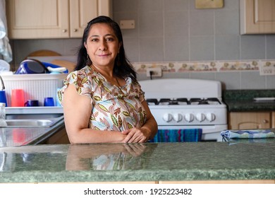 Proud Hispanic Woman Posing In Her Kitchen Clean-smiling Mom Standing In The Kitchen-woman In The Kitchen Not Cooking