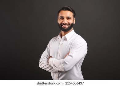 Proud Indian Male Businessman In White Smart Casual Shirt Stand With Arms Crossed Isolated On Black Background, Successful Hispanic Male Entrepreneur In Confident Pose