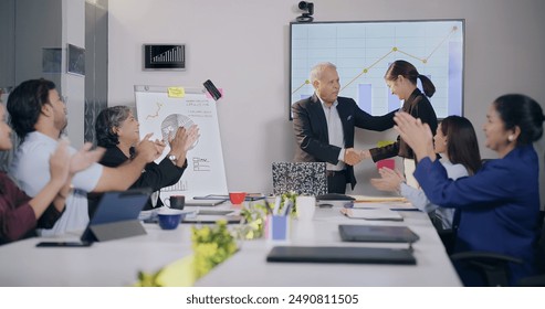 Proud Indian teen age female executive get promotion applause handshake boss team group clapping hand at office. Happy senior male ceo give best employee worker feedback congratulating  at work place - Powered by Shutterstock