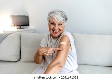 Proud mature woman smile after vaccination with bandage on arm. Beautiful smiling senior woman 70s after receiving the coronavirus vaccine. Elderly lady getting immunization via anti-viral vaccine. - Powered by Shutterstock