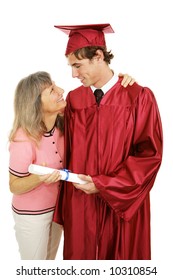 Proud mother congratulates her son on his graduation.  Isolated on white.