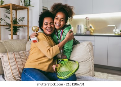 Proud mother feel so excited to see her daughter  medal and trophy in her hand after tennis tournament. - Powered by Shutterstock