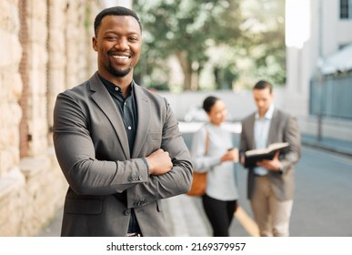 Proud Of My Career. Shot Of A Young Businessman Walking To Work With His Colleagues.