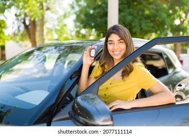 Proud Of My New Car. Gorgeous Latin Woman Smiling And Showing The Car Keys While Getting Into The Driver's Seat 