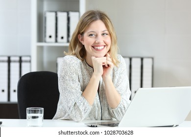 Proud office worker posing laughing and looking at side on a desktop