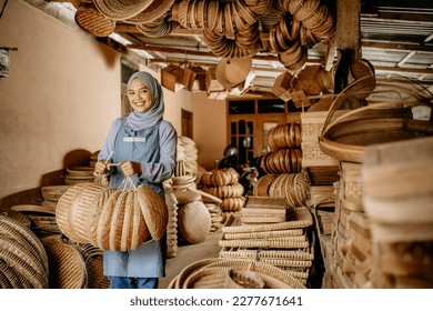proud seller holding her bamboo craft product and smiling to camera