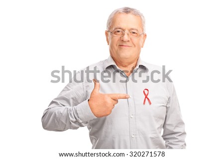Proud senior gentleman looking at the camera and pointing towards an AIDS badge on his shirt with his finger isolated on white background
