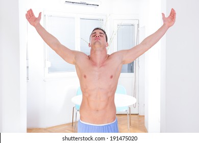 proud shirtless man in winning pose with hands up, serious young sexy muscular macho man posing in naked torso holding raised hands and arms up, man winner with athletic sport body raising hands