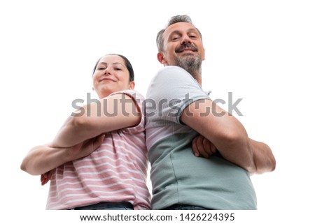 Proud smiling man and woman couple with arms crossed portrait from below isolated on white background