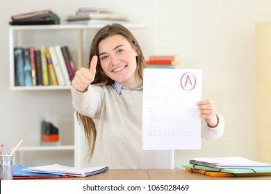 Proud student showing approved exam to camera at home