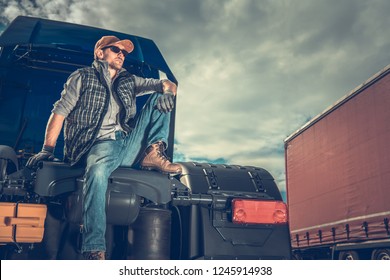 Proud Truck Owner. Transportation And Logistic Company.  Caucasian Men Relaxing On The Semi Tractor. 