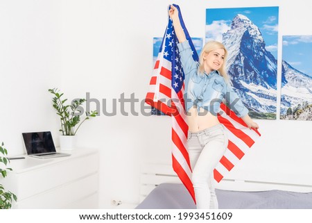 Proud woman with the American flag and smiling