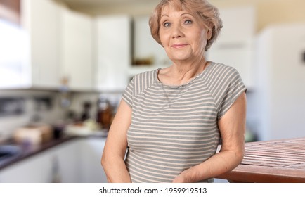 Proud Woman Posing In Her Kitchen Clean-smiling Mom Standing