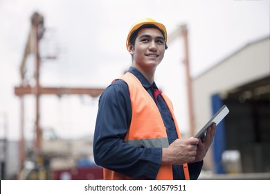 Proud Young Worker In Protective Work Wear In Shipping Yard