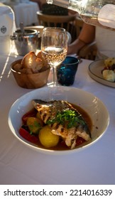 Provence Cuisine, Grilled Filet Of Seabass White Fish Served With Potatoes, Tomatoes And 
Bouillabaisse Fish Jus In French Restaurant